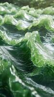 Waves of translucent green sea water with swirling patterns under sunlight create a mesmerizing coastal view at midday photo