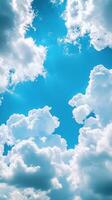 Beautiful fluffy clouds in a bright blue sky during midday creating a serene atmosphere photo