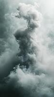 Mysterious formation of swirling mist rises dramatically against a soft, muted background photo