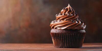 Delicious chocolate cupcake topped with creamy frosting and chocolate chips on rustic wooden table photo
