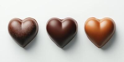 Gourmet heart-shaped chocolates in various cocoa styles arranged on a white background photo