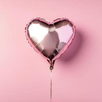 Heart-shaped balloon floating against a soft pink backdrop for a festive celebration or romantic occasion photo