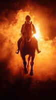 Dramatic silhouette of a horse and rider amidst fiery background during nighttime event photo