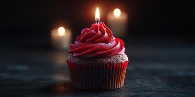 Delicious chocolate cupcake with bright red frosting and a lit candle, ideal for celebrating special occasions photo