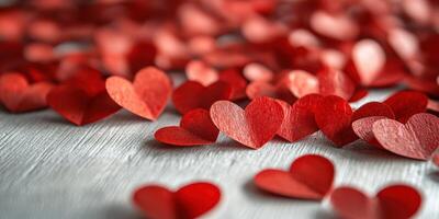 Festive red paper hearts scattered on a wooden surface for romantic occasions or celebrations photo