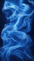 Ethereal blue fabric swirls gracefully against a dark background creating a tranquil ambiance photo