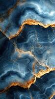 Abstract blue and gold stone pattern with swirling textures and intricate details forms a captivating natural design photo