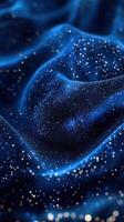 Sparkling blue fabric texture with shimmering particles creating a cosmic impression in soft waves photo