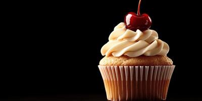 Delicious vanilla cupcake topped with creamy frosting and a cherry on a dark background photo