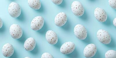 Decoratively arranged speckled eggs on a light blue background for seasonal celebration or artistic display photo