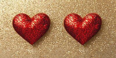 Glittering red hearts on a shimmering gold background create a festive and romantic atmosphere for celebrations photo