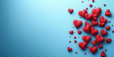 Red hearts scattered on a blue surface for a romantic or festive occasion photo