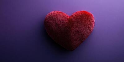 Heart-shaped cushion on a purple surface ideal for romantic settings or cozy decorations photo
