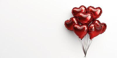 Heart-shaped balloons in bright red color floating against a plain background for a romantic celebration or event photo