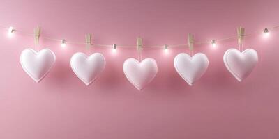 Heart shaped decorations hanging on a string with lights against a pink background for a festive celebration photo