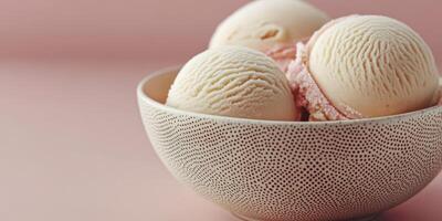 Delicious ice cream scoops served in a textured bowl against a soft pink backdrop photo