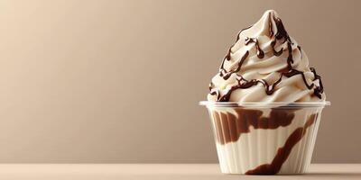 Soft serve ice cream topped with chocolate drizzle in a clear cup placed on a neutral background photo