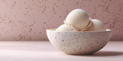Delicious creamy vanilla ice cream balls served in a decorative speckled bowl on a pastel background photo