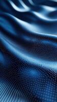 Smooth blue fabric with intricate dot patterns capturing light and creating depth and texture in a serene composition photo