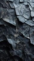 Textured black crumpled paper close-up reveals intricate patterns and tones in natural light photo