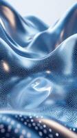 Flowing blue fabric with intricate patterns softly illuminated in gentle light photo