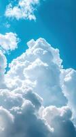 Fluffy white clouds drifting in a bright blue sky during a sunny afternoon photo