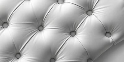 Soft white tufted leather upholstery with buttons providing elegant texture and comfort photo