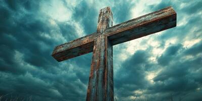 Weathered wooden cross under dramatic stormy sky at dusk in a remote field photo