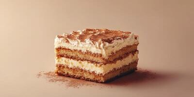 Delicious layered dessert sits on a neutral background highlighting its creamy filling and dusted cocoa photo