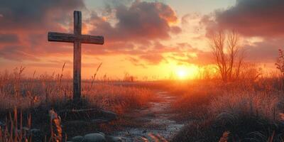Beautiful sunset over a serene field with a wooden cross symbolizing peace and reflection photo