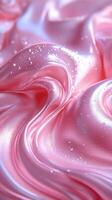 Soft pink silk fabric flows gracefully with shimmering water droplets reflecting light in a delicate pattern photo