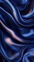 Smooth navy silk fabric elegantly draping in gentle waves, creating a luxurious and sophisticated texture photo