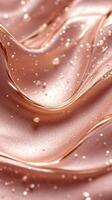 Swirling rose gold liquid texture with delicate bubbles capturing light and reflections photo