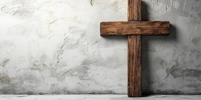 Wooden cross displayed against a textured wall in a serene and spiritual setting photo
