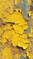 Vibrant yellow paint peeling off a textured wall revealing an interesting pattern and contrasting colors in an urban setting photo