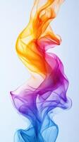 Colorful smoke swirling gracefully in the air with vibrant hues of yellow, orange, pink, and blue against a light backdrop photo