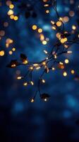 Twinkling string lights adorning branches illuminate the night sky in a tranquil setting photo
