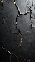 Cracked black surface revealing golden layers beneath in an artistic display of texture and contrast photo
