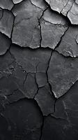 Cracked black surface revealing intricate patterns and textures in natural stone formation under close observation photo