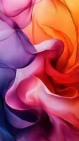 Colorful swirling fabric creating an abstract design with vibrant hues and soft textures in shades of purple, pink, orange, and red photo