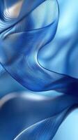 Elegant blue silk fabric gracefully flowing in a soft wave pattern under gentle light photo