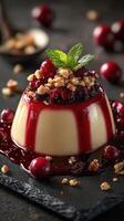 Creamy dessert topped with cherry sauce and crushed nuts served on a dark surface photo