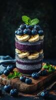 Delicious layered chia pudding with bananas and blueberries on a wooden surface photo