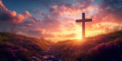 Sunset illuminates a cross over a blooming field with vibrant clouds in the serene evening sky photo