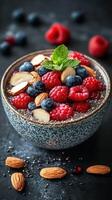 Healthy chia seed pudding topped with fresh berries and nuts ready for a nutritious breakfast or snack photo