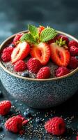 Chia seed pudding topped with fresh strawberries and raspberries in a rustic bowl photo