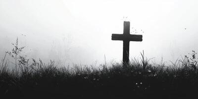 Cross stands alone in foggy landscape at dawn, symbolizing remembrance and reflection in nature's quiet embrace photo