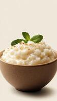 Delicious rice pudding served in a bowl with mint garnish and a sprinkle of cinnamon photo