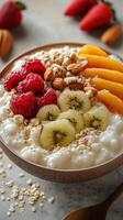 Healthy breakfast bowl with fruits, nuts, and oats prepared on a wooden table in a bright kitchen photo