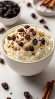 Delicious creamy rice pudding topped with chocolate shavings and raisins in a cozy kitchen setting photo